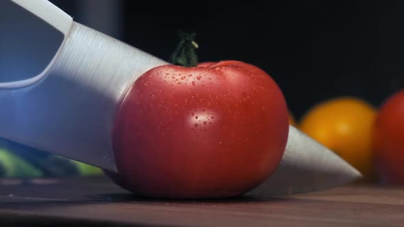 Professional Cook Cuts i Half Red Tomato with Steel Knife alt