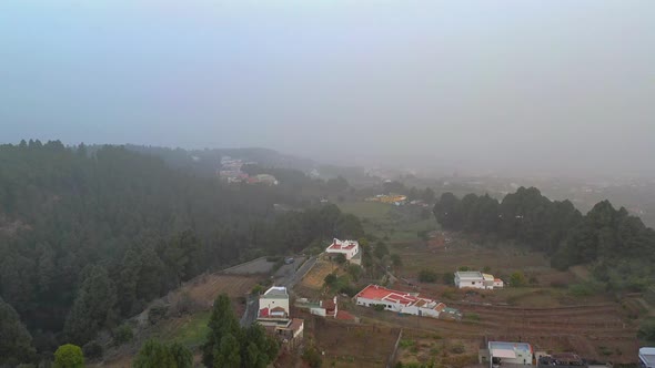 A small coastal village in the Canary Islands,Spain,the whole are covered with heavy fog. alt