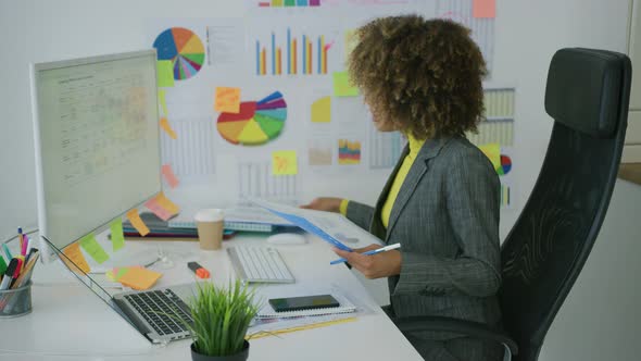 Concentrated Woman Watching Computer in Office alt