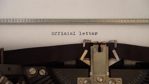 Typing phrase Official Letter on retro typewriter. Close up. alt