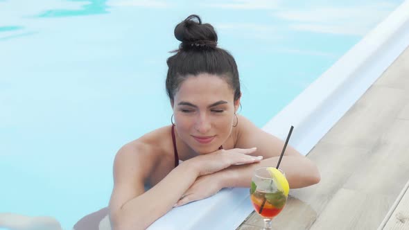 Beautiful Young Woman Relaxing After Swimming in the Pool alt