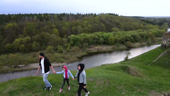 Happy family enjoys the view on the coast Sluch river hills, Gubkiv village