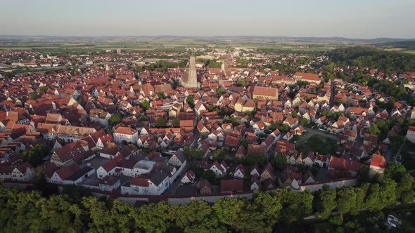 Aerial orbit of historical Nordlingen town centre at sunset, Bavaria Germany alt