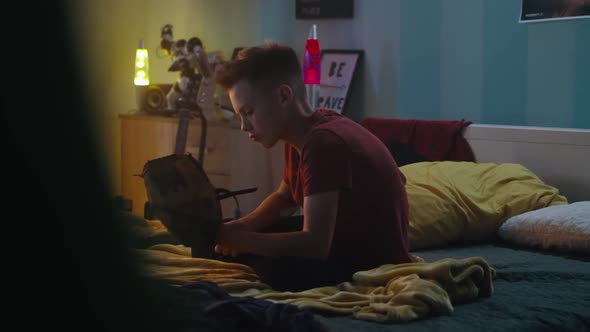 Bored Teenager Playing with Baseball Ball alt