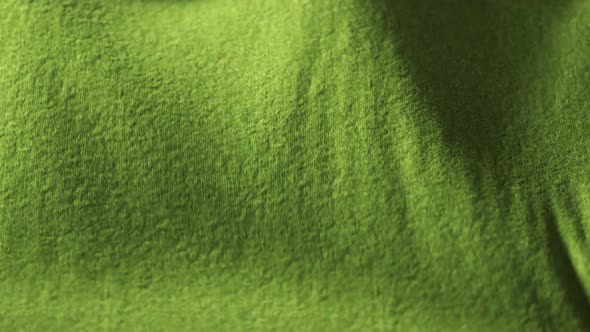 Highly detailed green cloth fabric fluttering on the wind. Loopable animation 4K