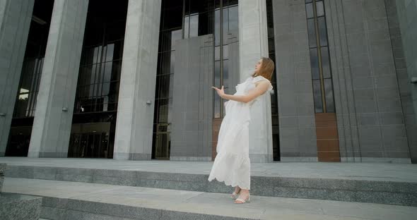Young Dancer in White Dress Does Leg Swing in Slow Motion Outdoors Balerina Dances in the Gallery of alt