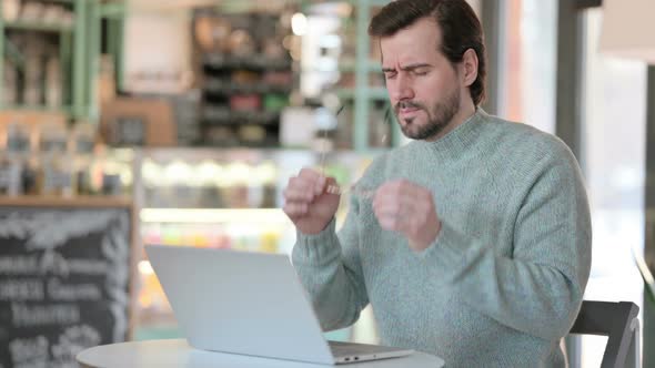Young Man Headache While Typing Laptop alt
