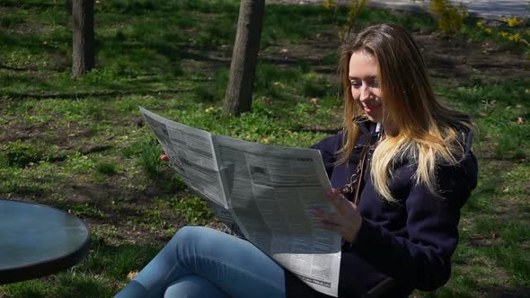 Gorgeous Girl Reads Gossips in Newspaper.