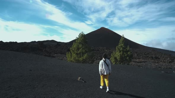 Woman Traveler Walks Through the Lava Field Around Chinyero Volcano in the Teide National Park on alt
