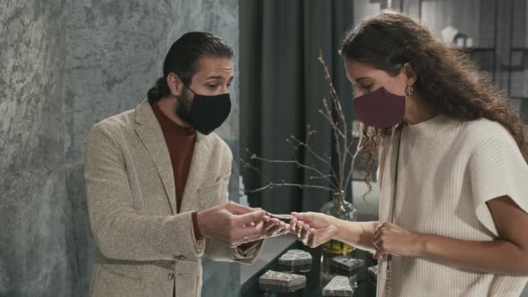 Man Selling Bracelet to Woman alt