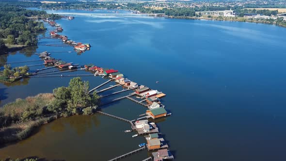 Flying Over Fishing Houses on the Lake Shore, Hungary alt