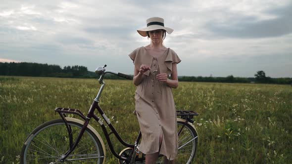 A Woman is Sitting on a Retro Bike