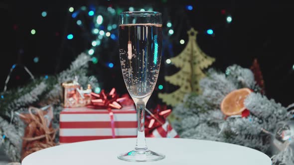 A glass of champagne with bubbles on the background of New Year's lights.Holiday concept.