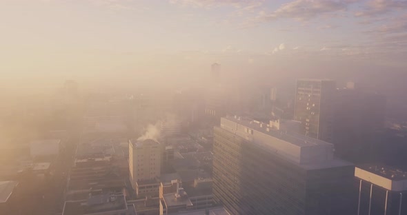 Drone Flying Over The City on a foggy morning