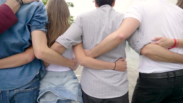 Confident group of friends standing in a row in city alt