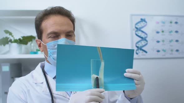 Male Gastroenterologist Showing Patient Picture With Milk, Lactose Intolerance