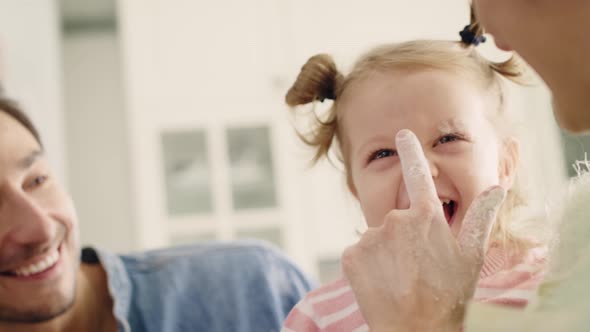 Handheld view of happy family spending time in the kitchen. Shot with RED helium camera in 8K    alt