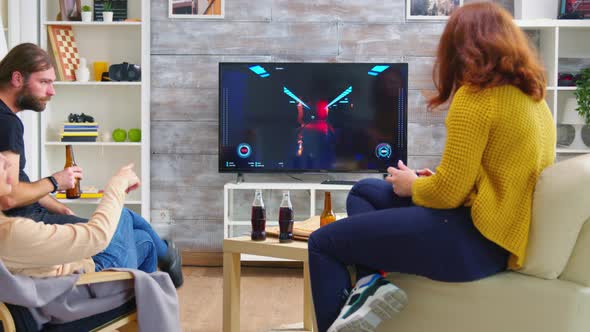 Back View of Young Woman Playing Video Games on Tv alt