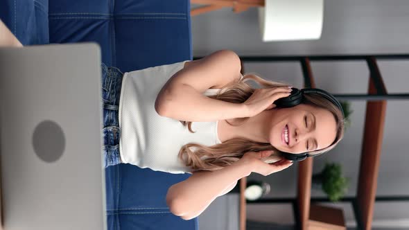 VERTICAL VIDEO POV Relaxed Woman Smiling Listening Music in Headphones Use Laptop Spending Time alt