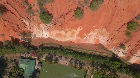 Aerial Slowmotion Shot of a Red Canyon or Fairy Stream at the Border of Desert in the Mui Ne Village alt