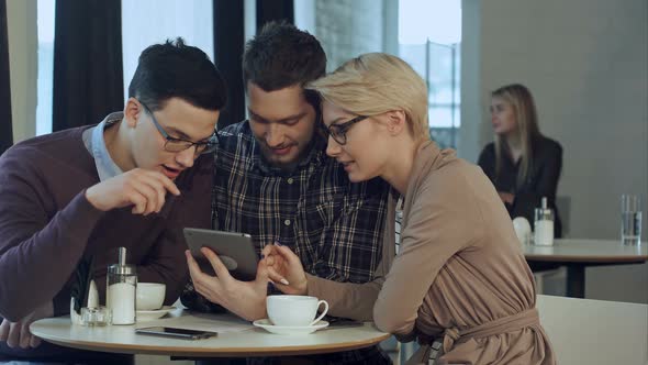 Creative Team Using Smartphone and Talking in Casual Office alt