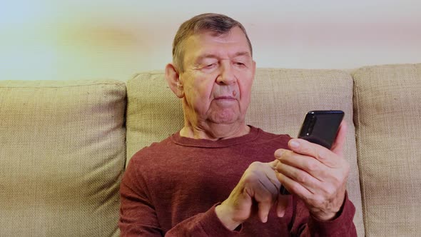 Elderly Man Dials Number and Speaks in Smartphone From Home