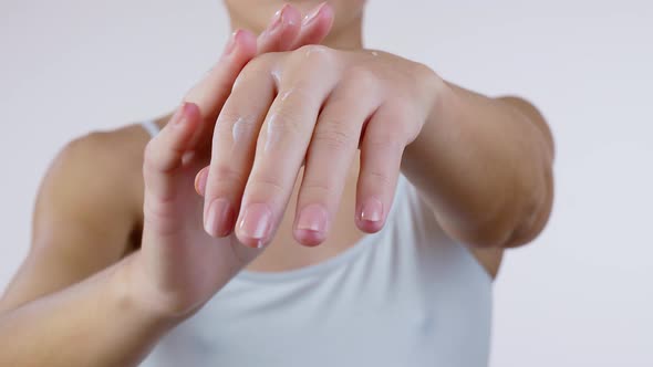 Woman Applying Cosmetic Hand Cream on Hand