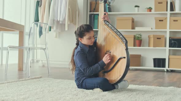 A Teenage Girl Plays the Bandura a Ukrainian Folk Ethnic Instrument alt