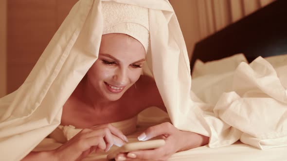 Woman Use of Mobile Phone and Read on Cellphone at Night alt