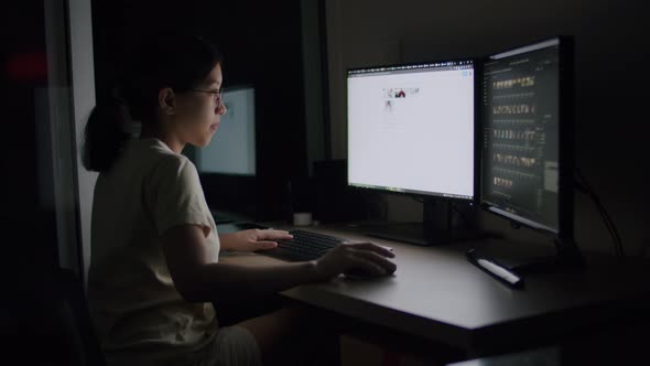 Asian female freelance wearing glasses typing keyboard on computer.