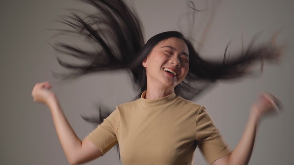 Asian woman happy relax and dancing isolated over background.