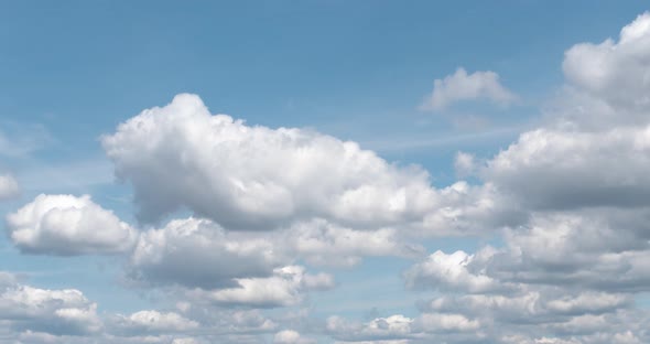 White Puffy Clouds Drifting Across Blue Sky in Time Lapse