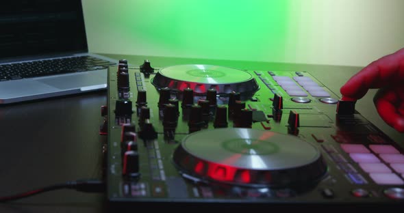 Male DJ Hands Turning Controls And Mixing 20B