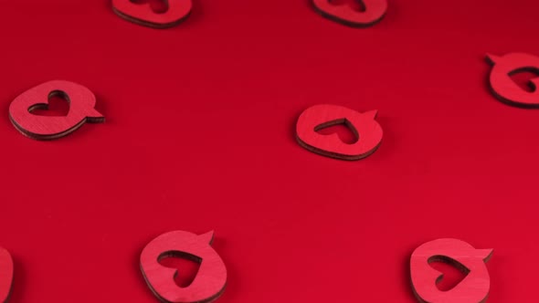 Red Rotating Background with Decorative Wooden Hearts