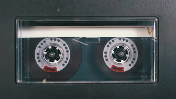 Audio Cassette Is Inserted Into the Deck of the Audio Tape Recorder Playing and Rotates alt