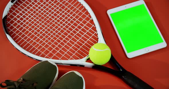 Digital tablet and sports equipment on red floor 4k alt