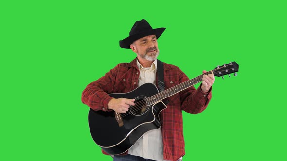 Man in Cowboy Hat Playing on Guitar and Singing on a Green Screen Chroma Key alt