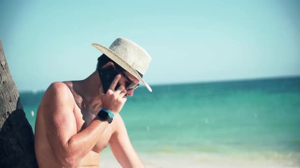 Happy Guy Resting On Coast Hotel Luxury. Lying On Tropical Beach. Sitting On Palm. Man On Vacation. alt