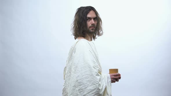 Good Jesus Holding Wooden Cup, Religious Concept to Give Drink to Thirsty alt