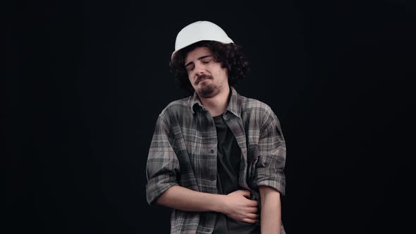 Amused Hipster with Curly Hair with His Finger in Front of Him He Was Having Fun Holding His Belly alt