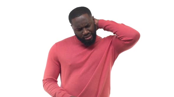 Slow Motion Handsome African American Bearded Man Frustrated Touching Back Neck Frowning Squinting alt