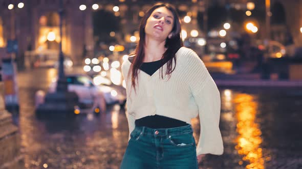 young woman performs modern dance steps on the street at night alt