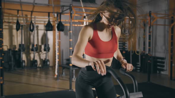 Woman Training on Exercise Bike alt