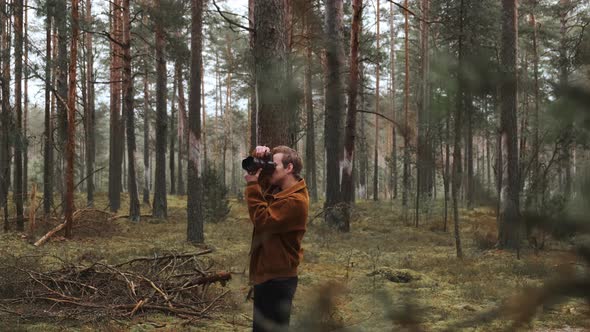 A Photographer Takes Pictures in the Woods a Young Man Takes Pictures in the Woods with His Camera alt