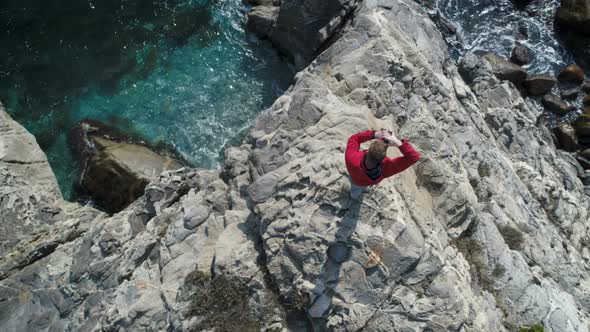 Overhead View Of Traveler Standing On The Cliff While Taking Photos
