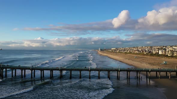 Drone shot flying backwards over a sand beach on the coast of California, America alt