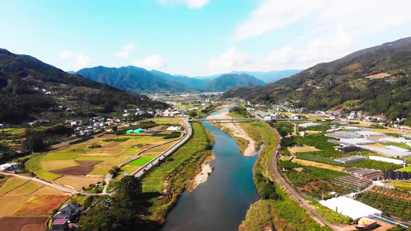 small village in japan alongside a beautiful river alt