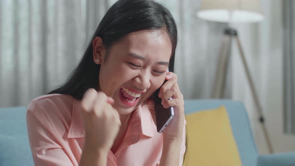 Close Up Of Asian Woman Answering The Call Then Being Happy While Looking At The Bill In Hand alt