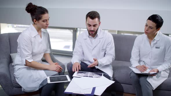 Male Dentist Conversing with Female Colleagues alt