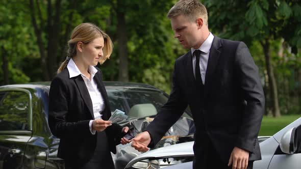 Female Driver Taking Dollars From Man Near Crashed Cars, Transport Accident alt